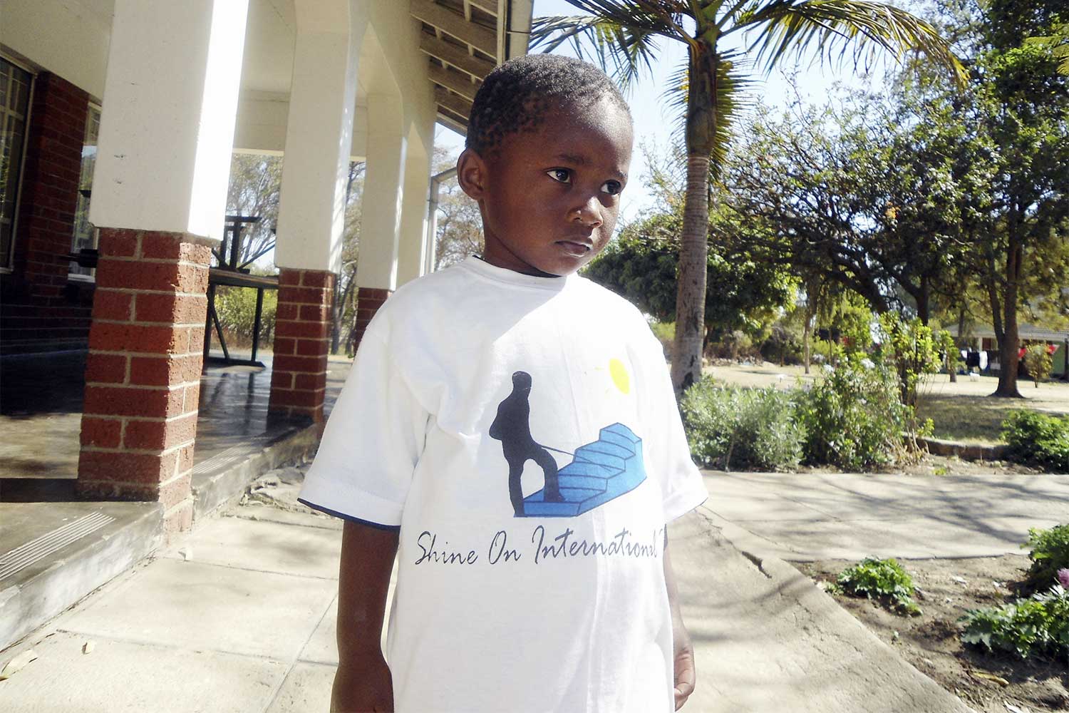 Boy with shirt from Shine on International Trust